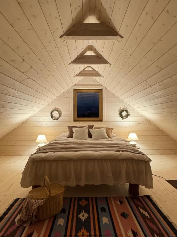 a bedroom with a large bed in a room at Dom w sadzie 