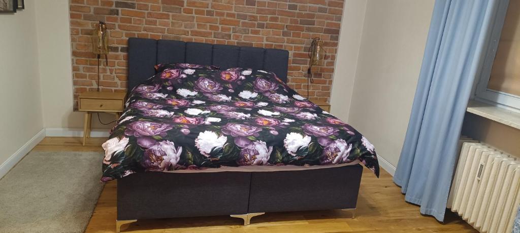a bed with a blanket on top of it at Poznań old city studio in Poznań