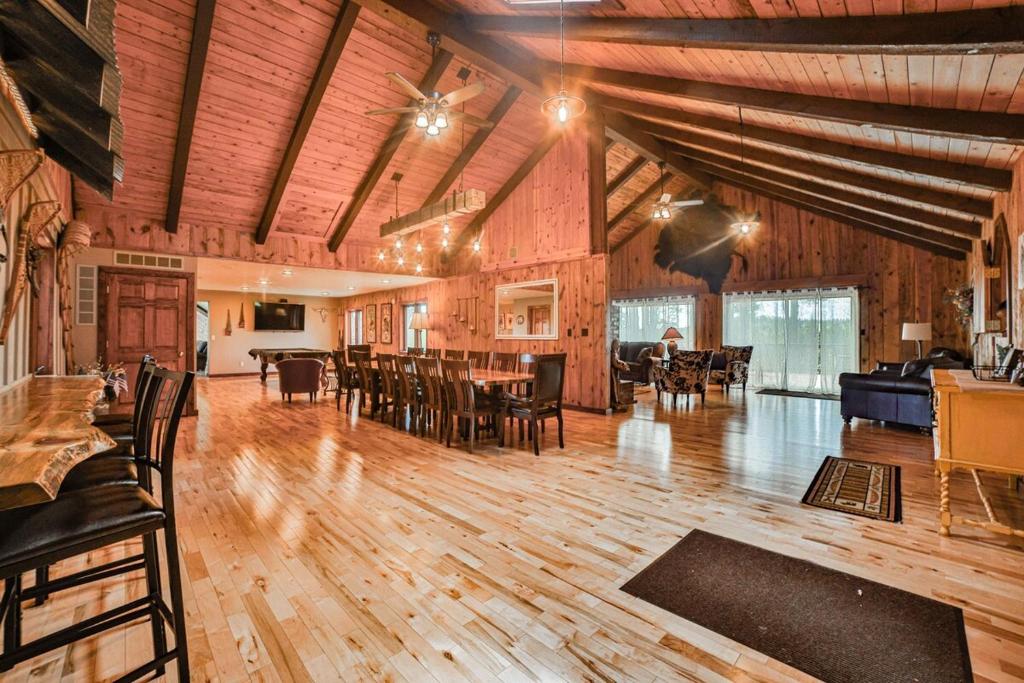 a large room with wooden floors and a table and chairs at Deadwood SD 11k sq ft 9 Bd Suites 11 Ba Sleeps 35 Plus in Deadwood