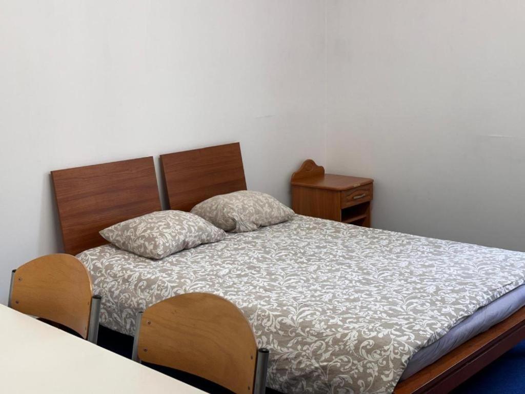 a bedroom with a bed with two pillows on it at Erasmus Genius Rooms in Poznań