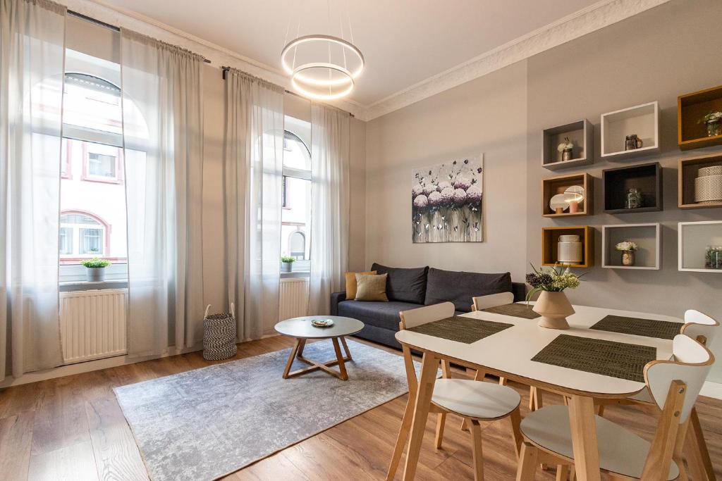a living room with a table and a couch at Family Apartment in Wiesbaden