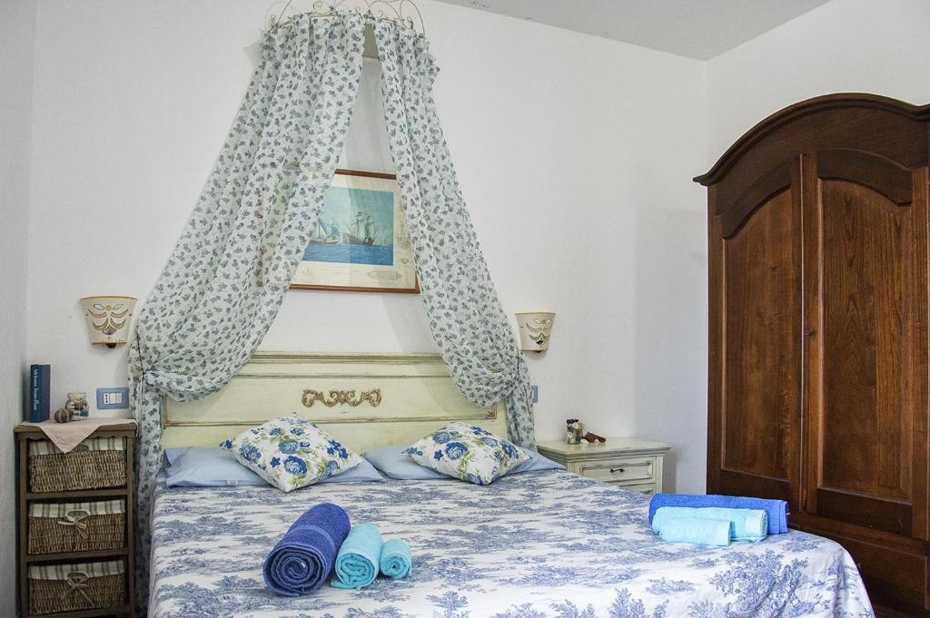 a bedroom with a bed with a canopy at Fiorerosa in Santa Maria Navarrese