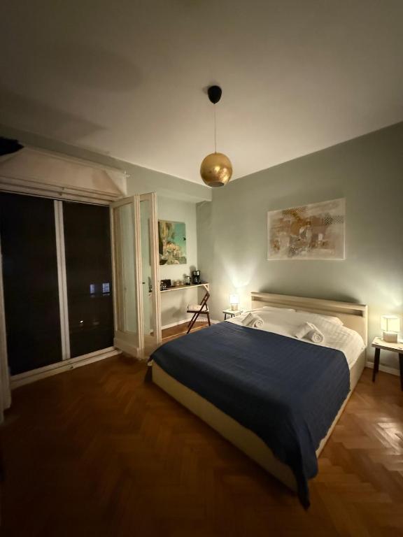a bedroom with a large bed and a large window at Cisimigu Garden Studio in Bucharest