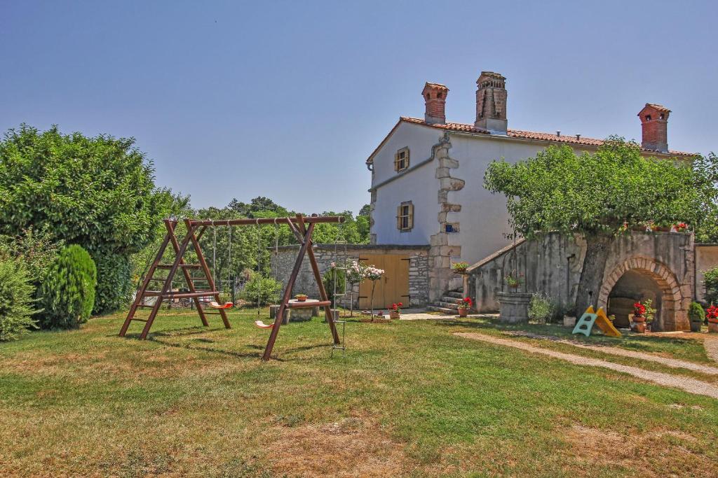 a playground in a yard next to a house at Erika in Šumber (Haus für 4-6 Personen) in Nedeščina
