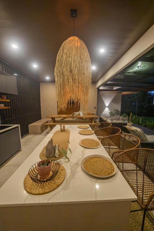 a dining room with a table with plates of food at Tropical Private Home for 8pp with pool in Talamanca