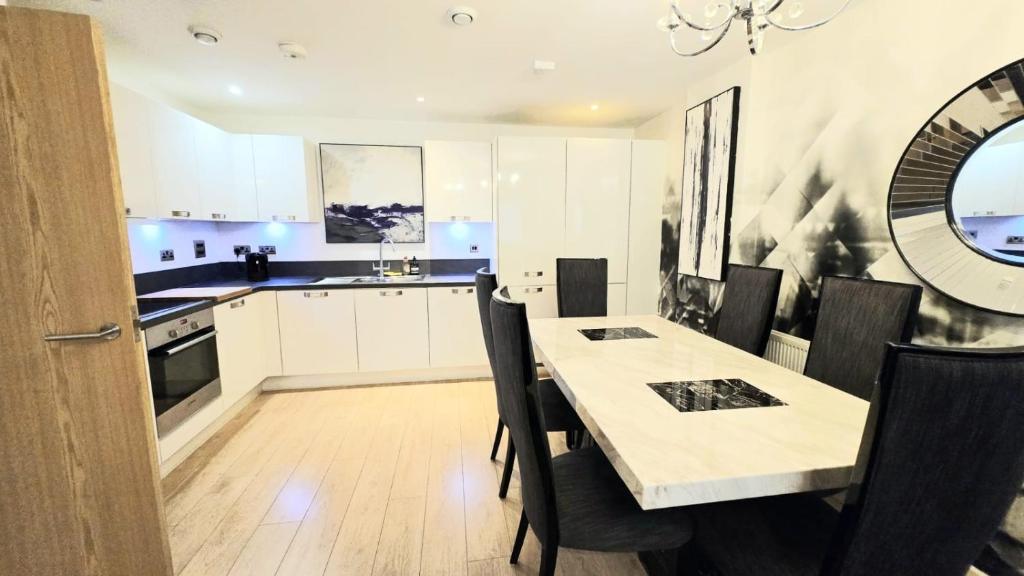 a kitchen and dining room with a table and chairs at The ascension 'Ascalon ' in London