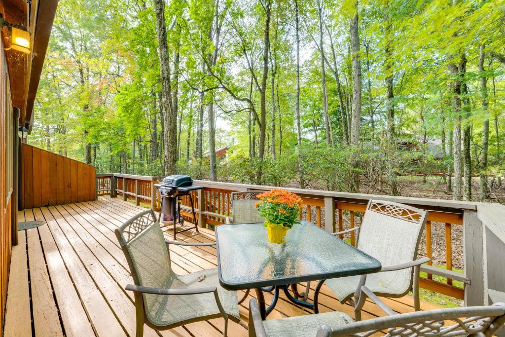 a patio with a table and chairs on a deck at Near Skiing and Lakes Contemporary Poconos Townhome in Lake Harmony