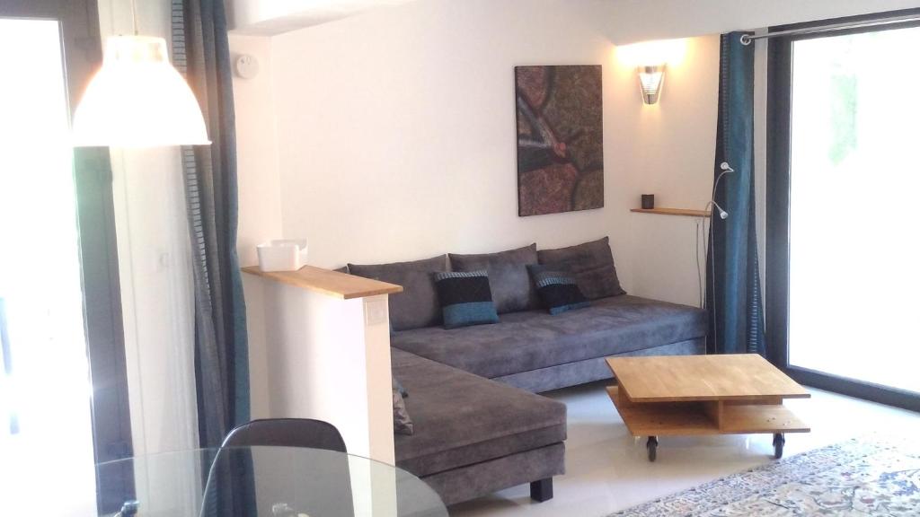 a living room with a couch and a table at Villa du Chateau in Nice
