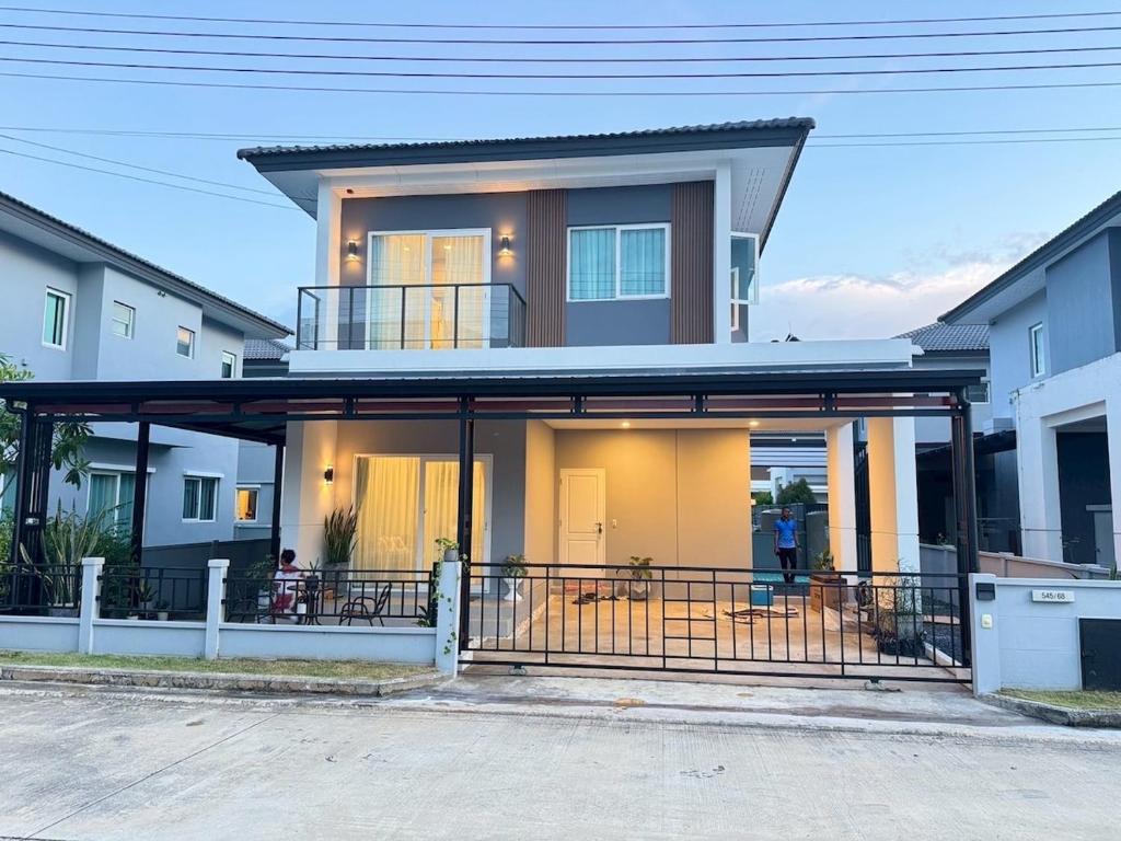 a house with a screened porch in front of it at Vela Nakhon Si Thammarat in Ban Nong Chaeng