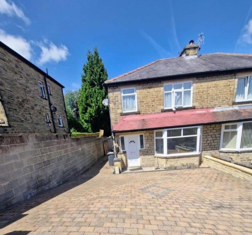a brick house with a driveway in front of it at 3 Bed Semi, Bingley, BD16, Free Parking, Wi-Fi in Bingley