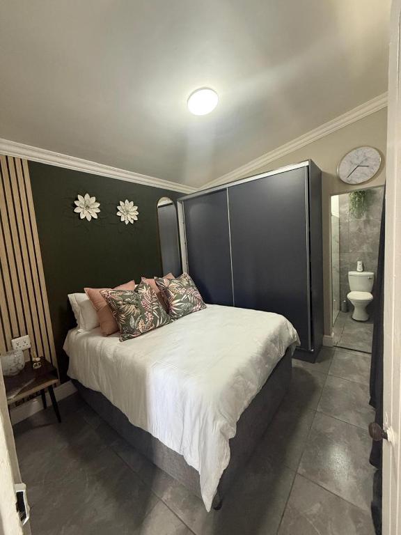 a bedroom with a large bed with a black headboard at 236 On Cape in Gqeberha