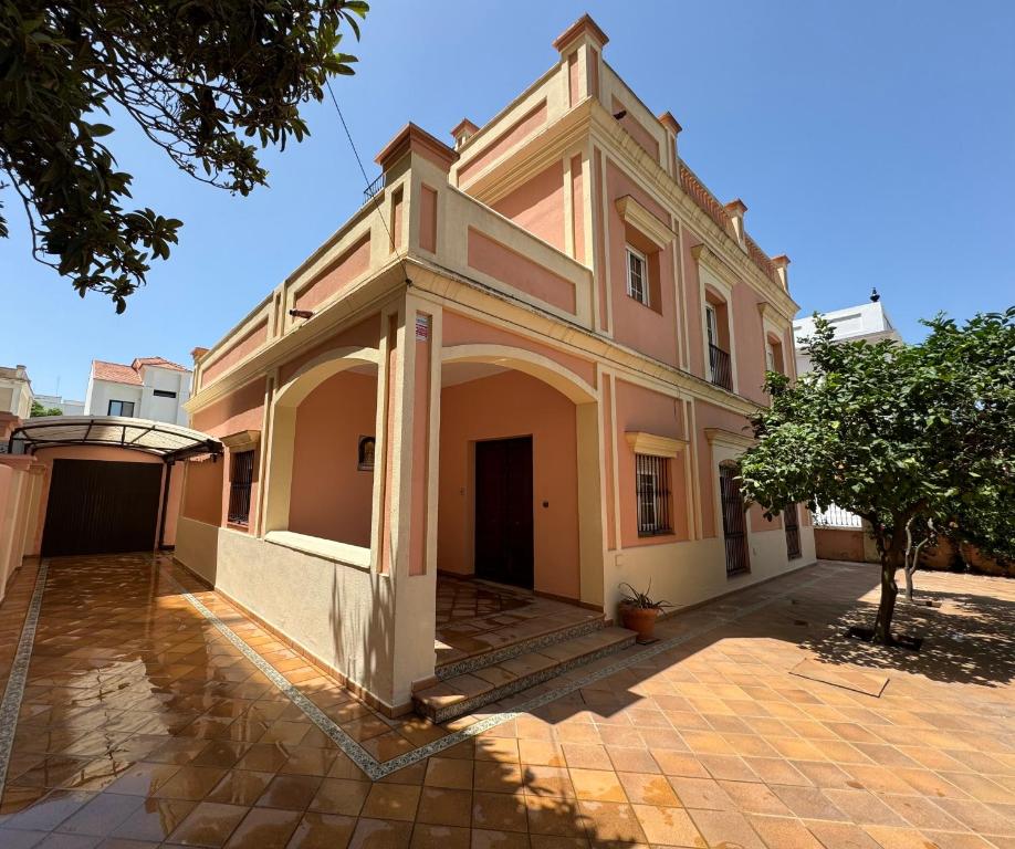 an old building with a tower on top of it at Chalet San Francisco in Sanlúcar de Barrameda