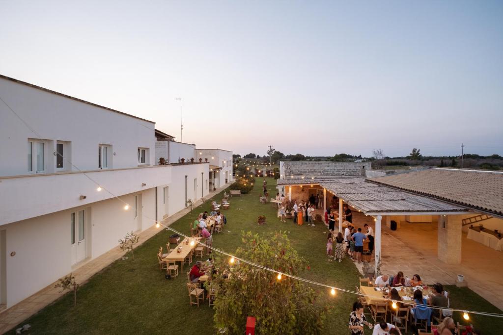 an overhead view of a group of people in a courtyard of a building at Masseria Rauccio in Torre dell'Orso