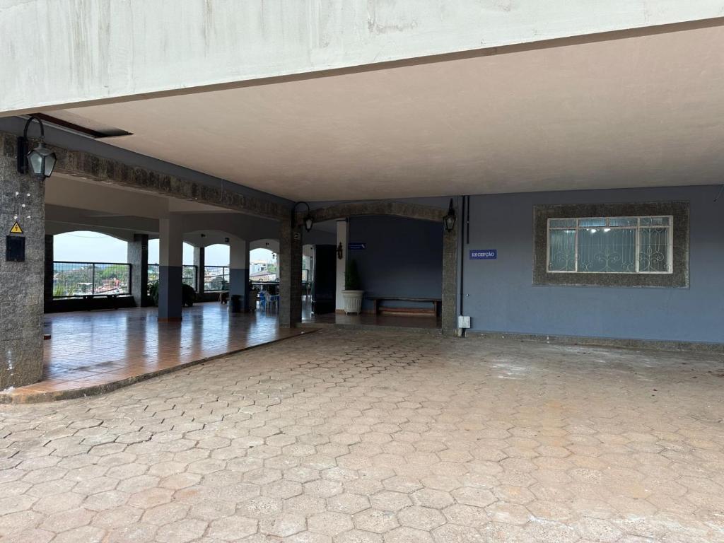 an empty room with a stone floor and blue walls at Castelo do Lago Hotel e Restaurante in Fama