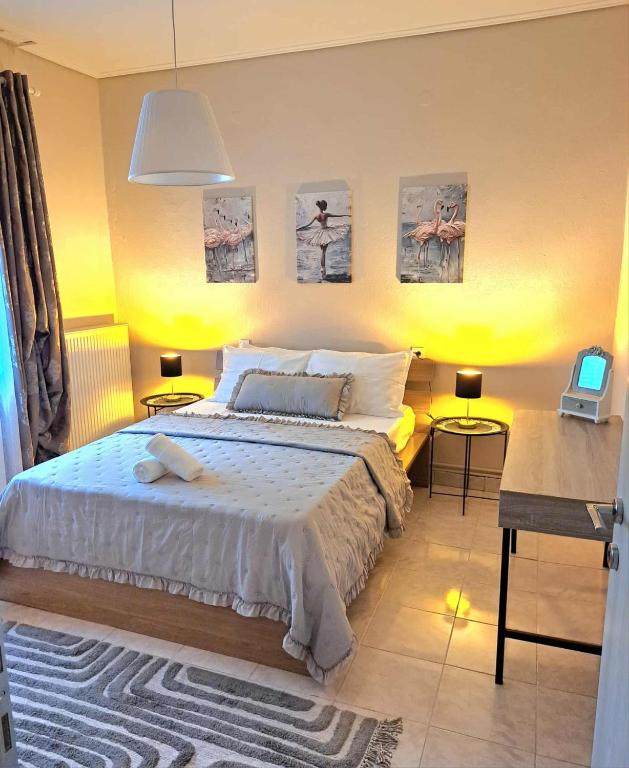 a bedroom with a bed and some pictures on the wall at Stelina's Guest House in Trikala in Tríkala