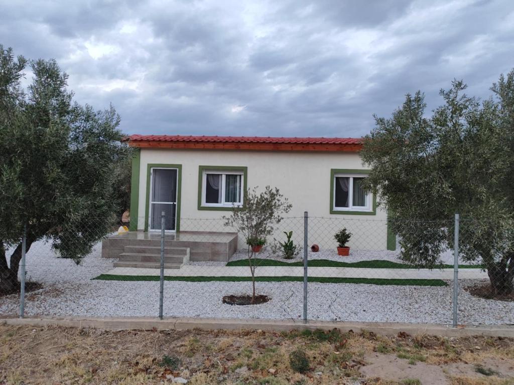 a house with a fence in front of it at Ismini's Luxury Villas in Mirodháton