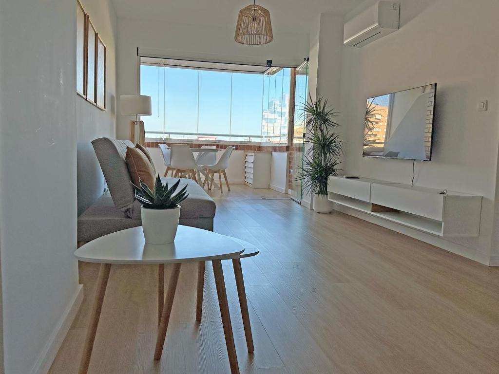 a living room with a couch and a table at Sol y Mediterráneo in Oropesa del Mar