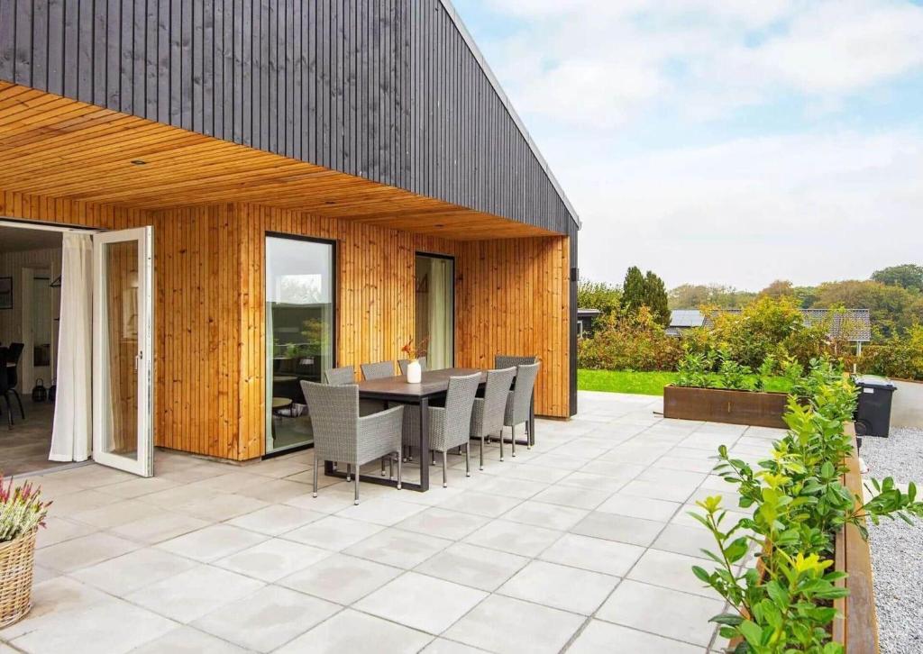 an outdoor patio with a table and chairs at SJ302-Haderslev-Blokhusskoven-63 in Kelstrup Strand