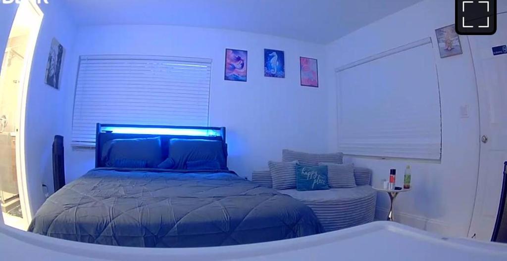 a bedroom with a bed and a bath tub at Family Willy Michel in Opa-locka