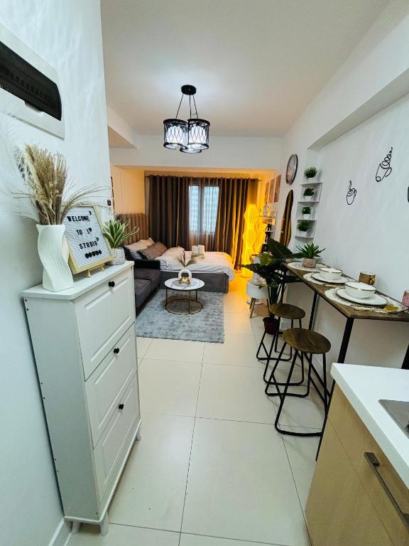 a kitchen and a living room with a couch at L Studio by Sella in Manila