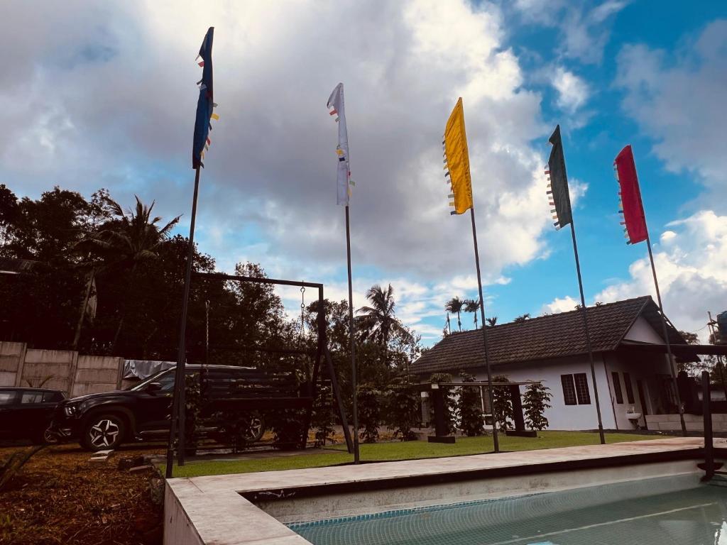 a group of flags in front of a house at Bambus Alley in Wayanad