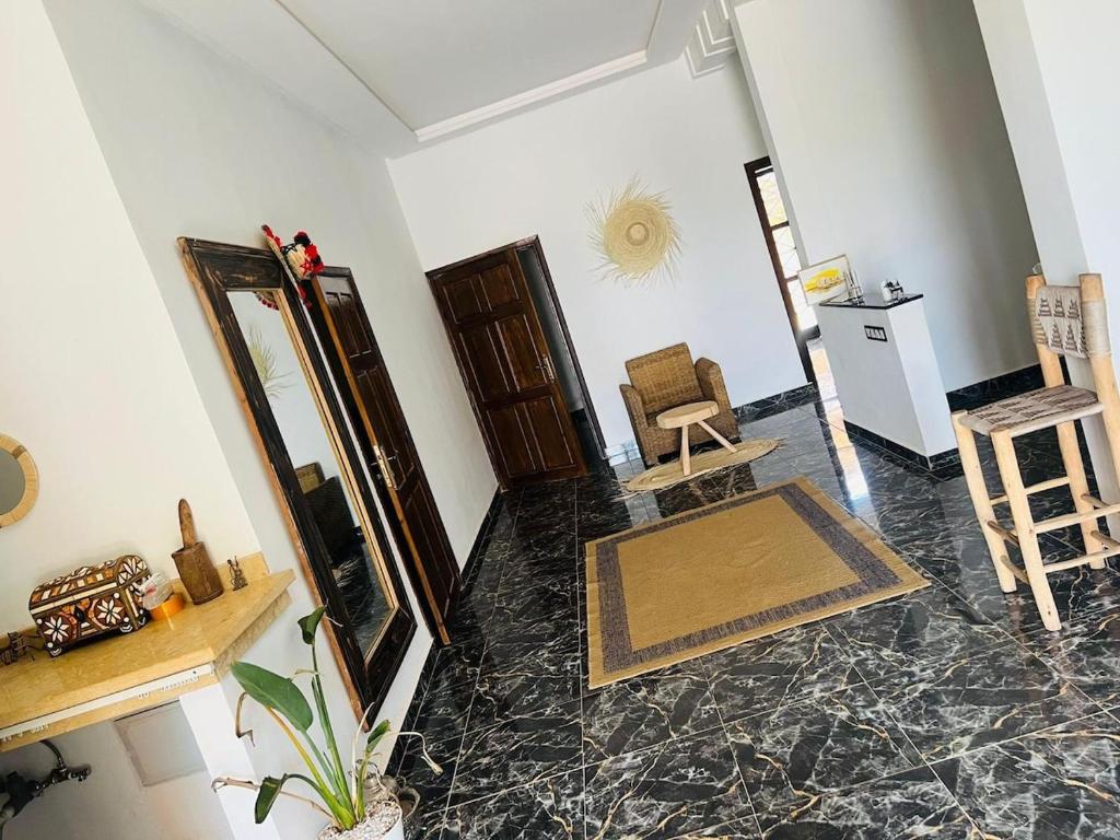 a living room with a mirror and a chair at Spacious and comfortable villa in Marrakesh