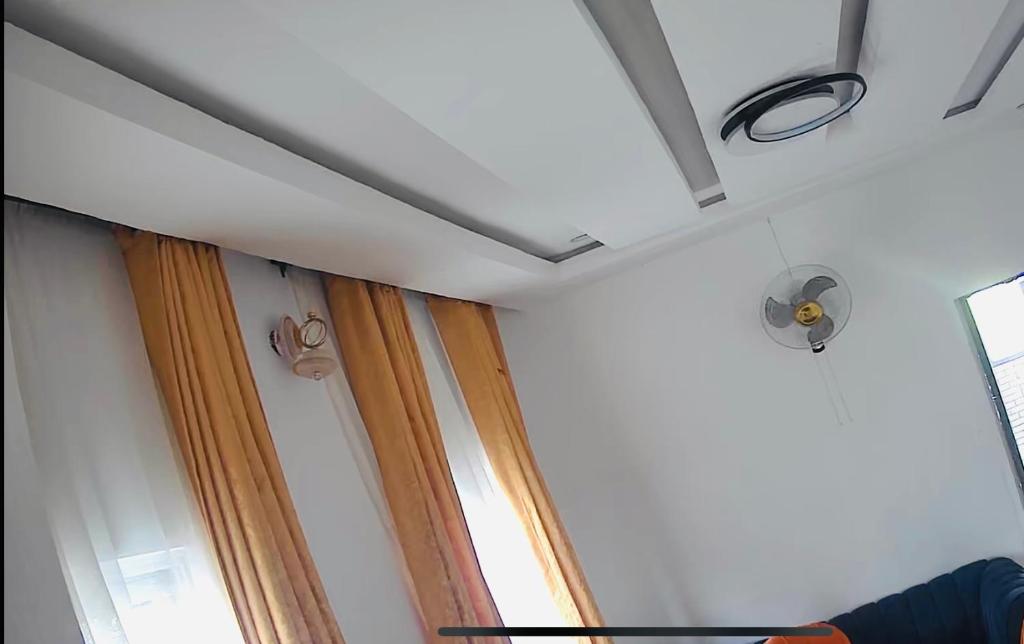 a room with two curtains and a window at Graceville Haven in Abeokuta