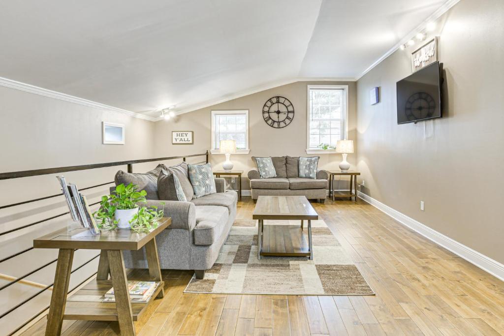 a living room with a couch and a table at Walk to Canal St Trolley! Mid-City NOLA Retreat in New Orleans