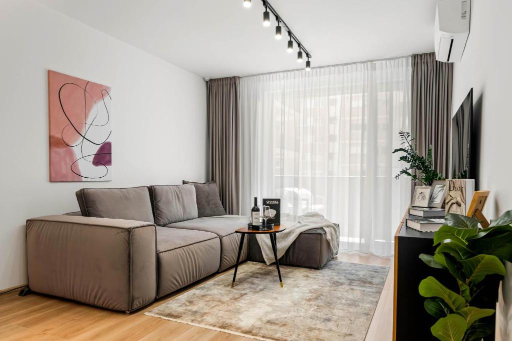 a living room with a couch and a table at SB Nest Apartment in Braşov