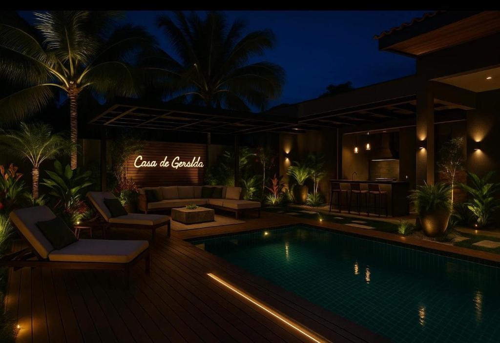 a villa with a swimming pool at night at Pousada Casa de Geralda in Altaneira