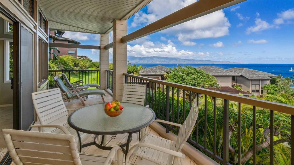 a balcony with a table and chairs and the ocean at Kapalua Ridge Villa 1112 in Kapalua