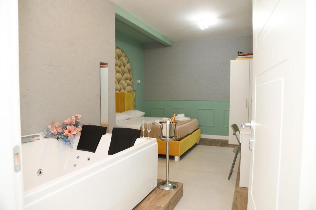 a living room with a bed and a mirror at Dello Iacono suite in Naples