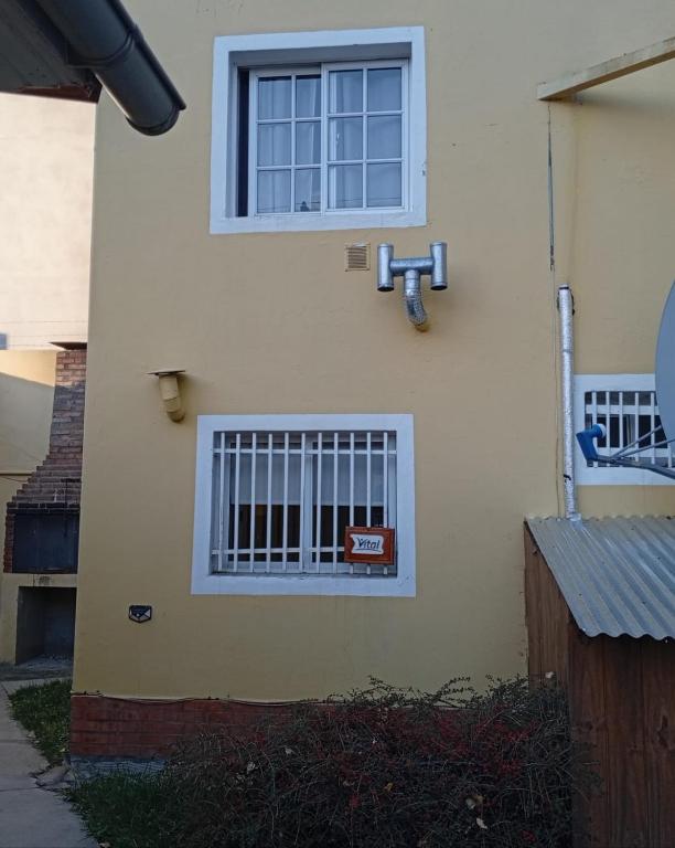 a building with a window with bars on it at Apart Vital 3 in El Calafate