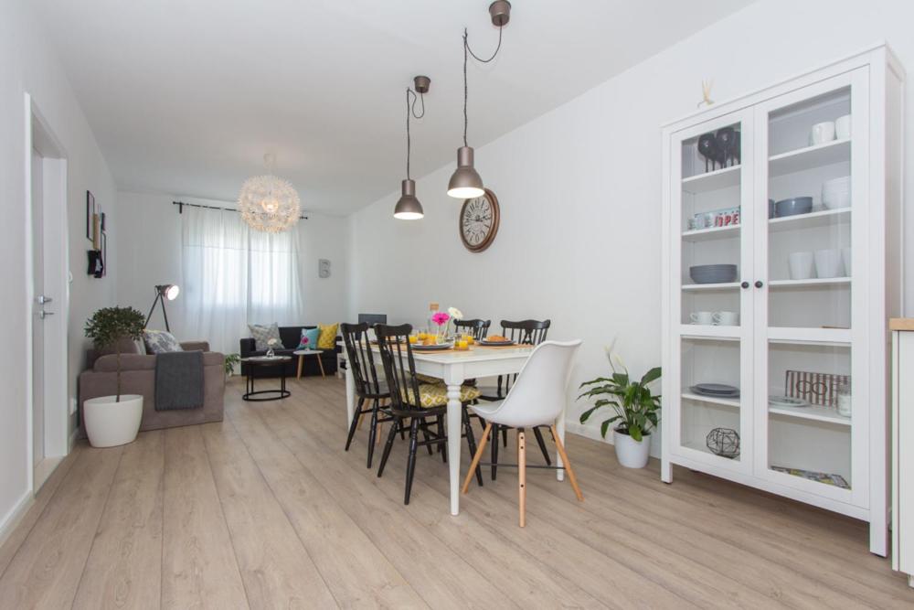 a kitchen and living room with a table and chairs at SplitSpirit Apartment in Split