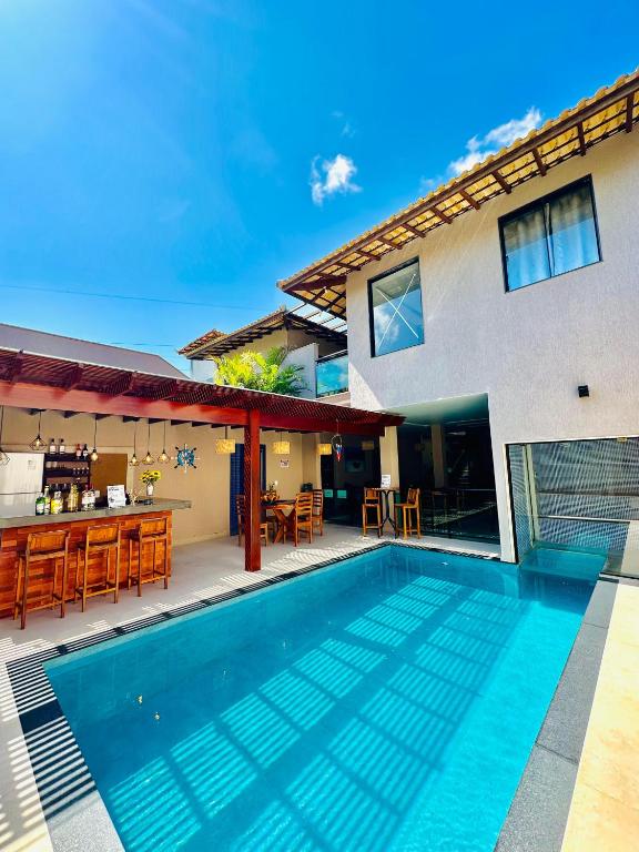 a swimming pool in front of a house at Pousada Amaral Búzios in Búzios