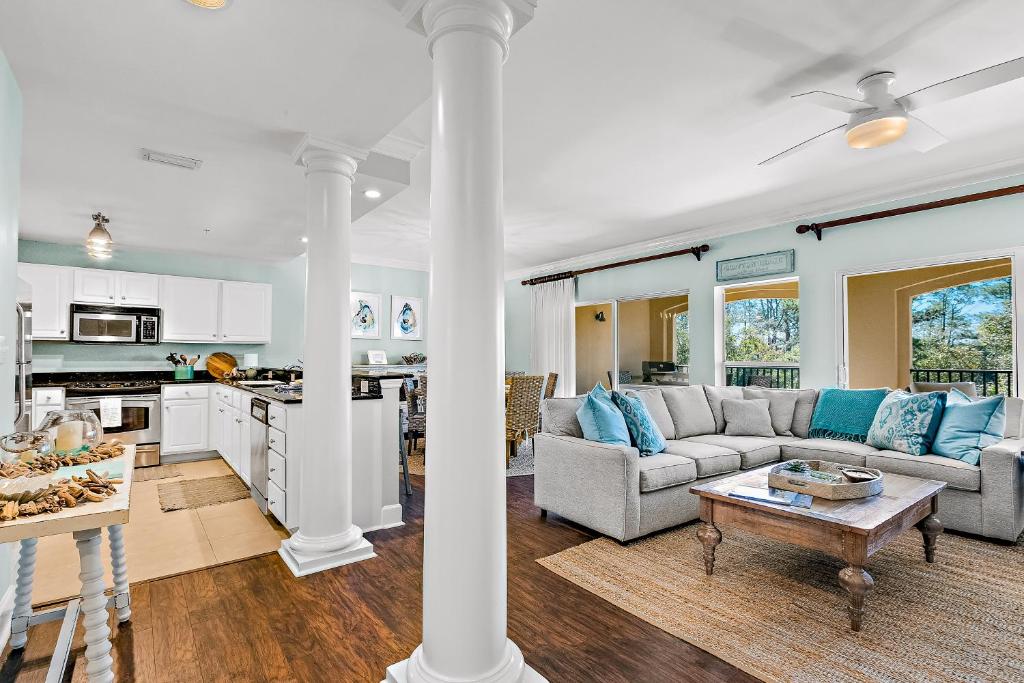 a living room with a couch and a table at The Preserve 202 in Blue Mountain Beach