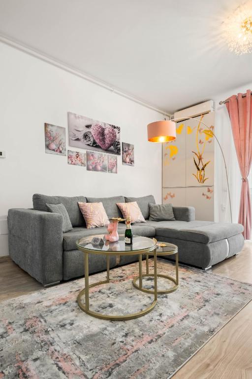 a living room with a couch and a table at Moonlight Flower in Mamaia