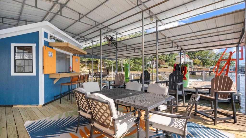 a patio with a table and chairs on a deck at Lake Home Oasis - Sleeps 18 in Lake Ozark