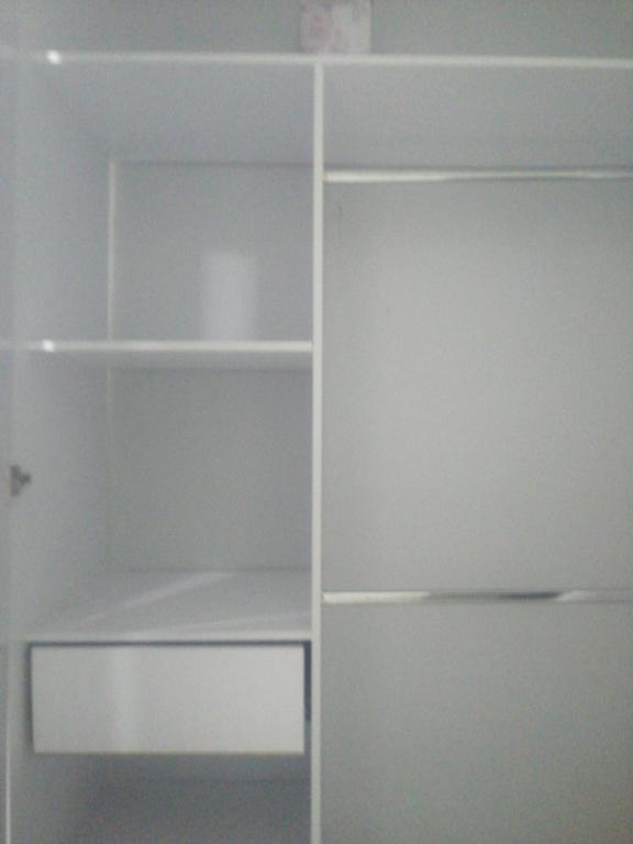 a white closet with white shelves in a room at Rey SALOMÓN SALJA in Barranquilla