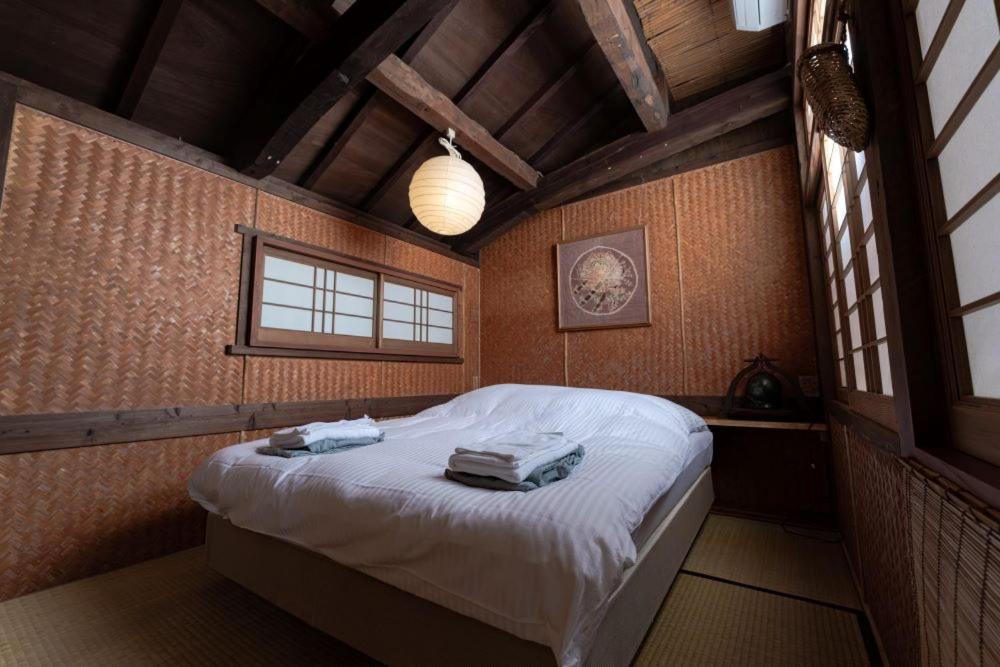 Giường trong phòng chung tại 車で市街地近くの静かな田舎空間一沖縄古民家の宿