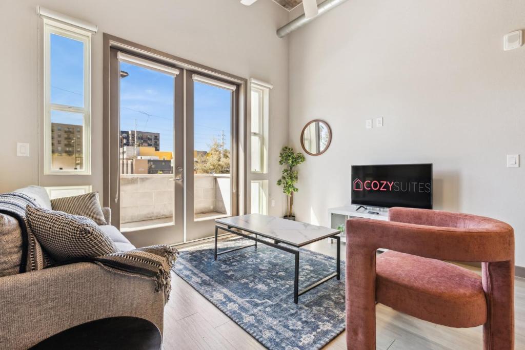 a living room with a couch and a table at CozySuites PHX RORO Gym Pool Pets & Parking #15 in Phoenix