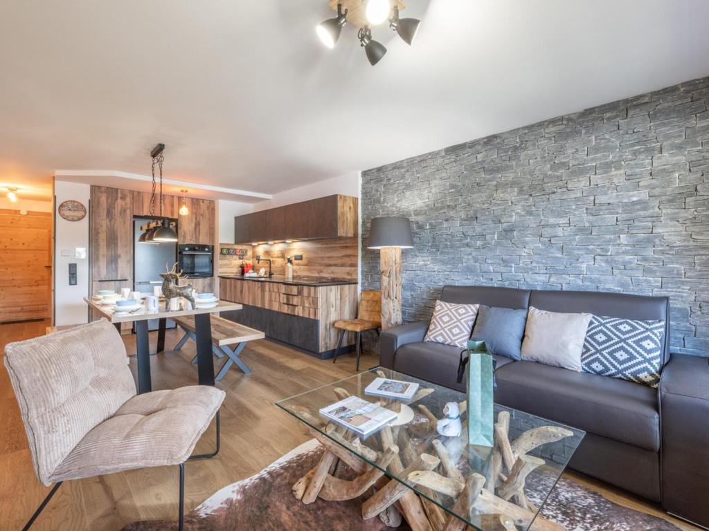 a living room with a couch and a table at Appartement moderne, Alpe d'Huez, 6 pers, cosy et pratique - FR-1-645-87 in L'Alpe-d'Huez