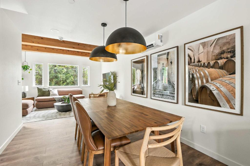 a dining room with a wooden table and chairs at The Adelynn - Luxury 2BR Home in Walkable Portland in Portland