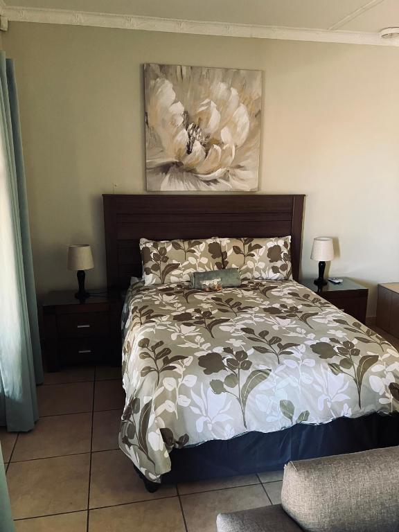 a bedroom with a bed and a painting on the wall at Willow Cottage in Evander
