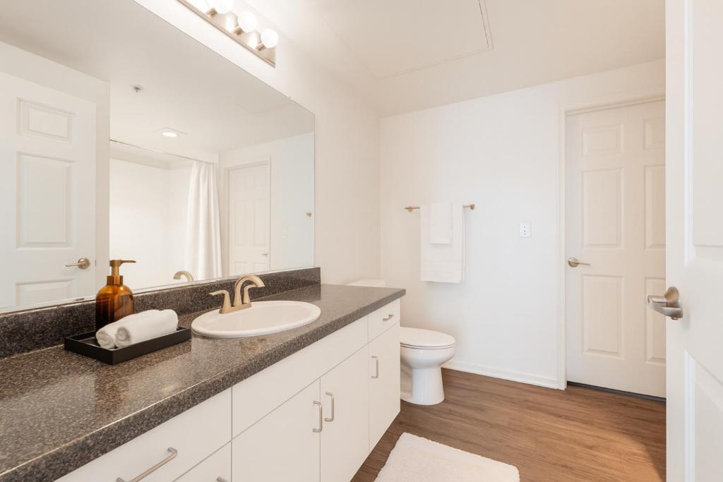 a white bathroom with a sink and a toilet at Venice Boardwalk Breeze 2BR - 7-min to Venice Beach in Los Angeles