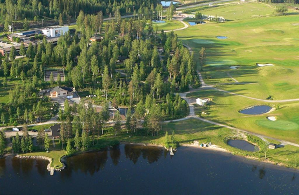 an aerial view of a golf course with a lake at Revontuli Resort Cottages in Hankasalmi