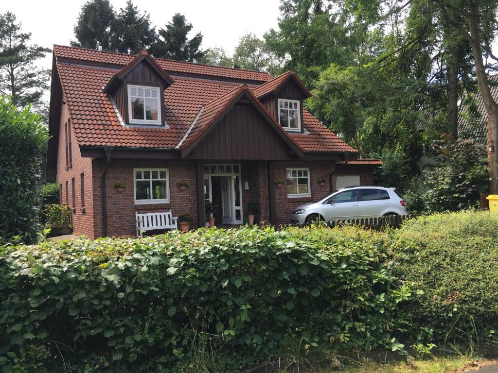 a house with a car parked in front of it at Bed & Breakfast Bigalke in Hamburg