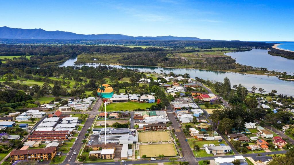 an aerial view of a town next to a body of water at Myee Court in Urunga
