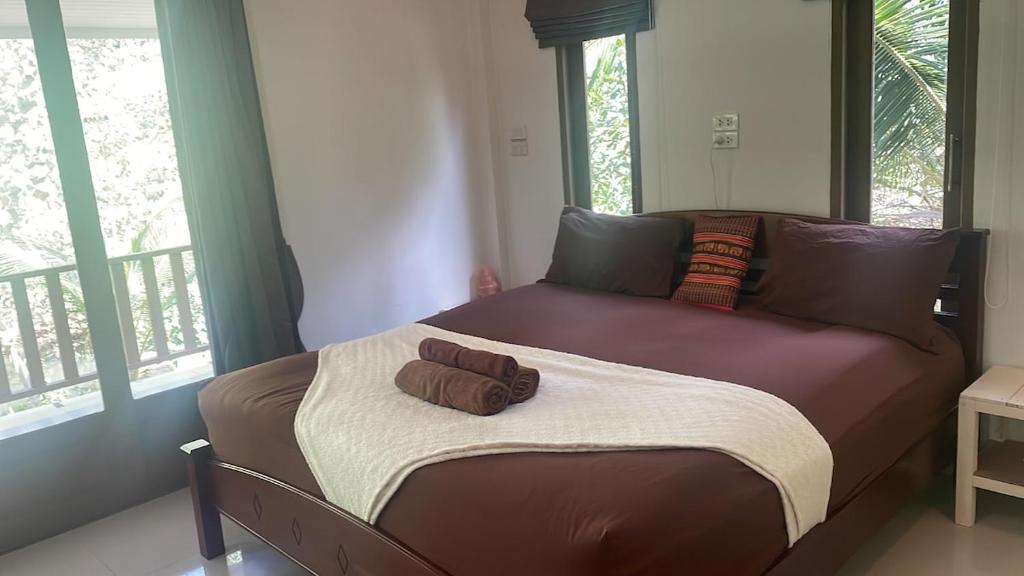 a bed in a room with two pillows on it at Canal hut 2 - Chaloklum in Chaloklum