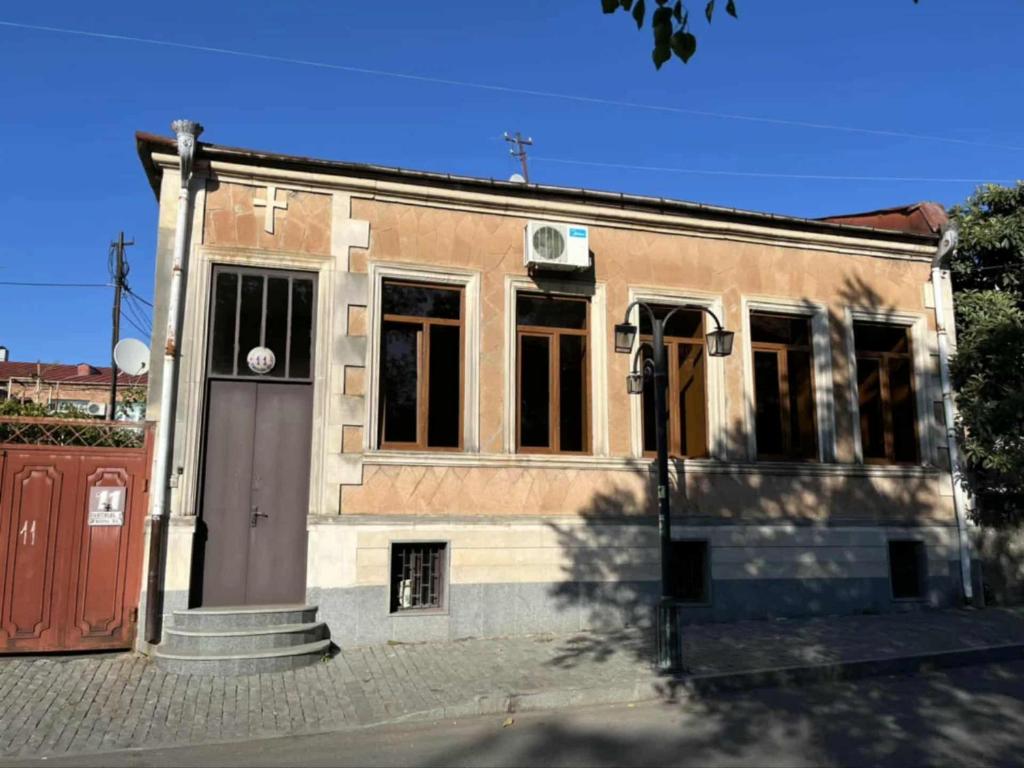 a building with a door on a street at City center house in Kutaisi